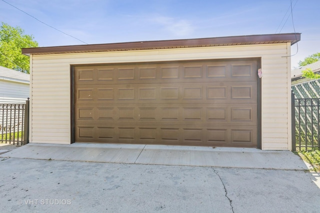 detached garage featuring fence