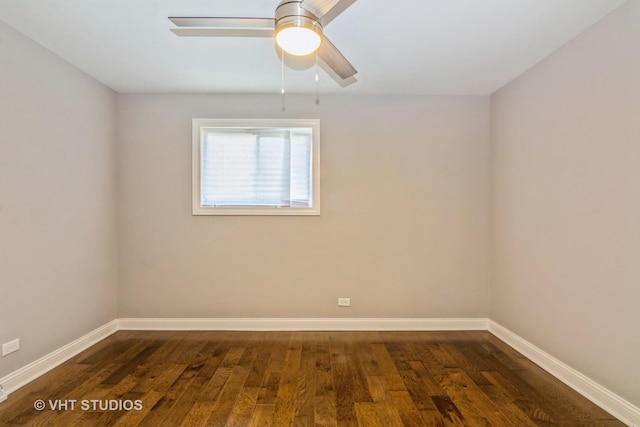 spare room featuring dark wood-style floors, baseboards, and ceiling fan