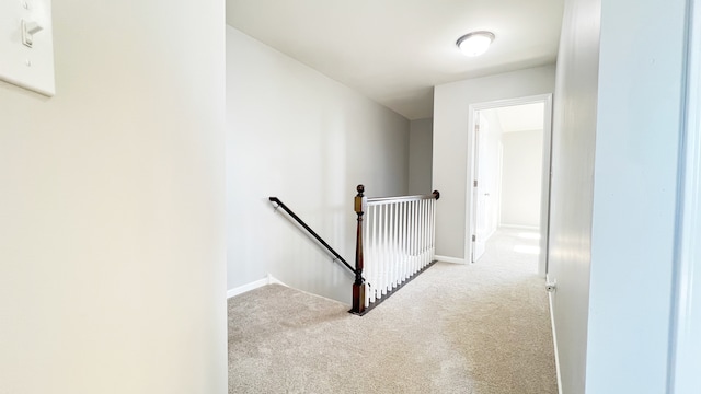 hall featuring light colored carpet