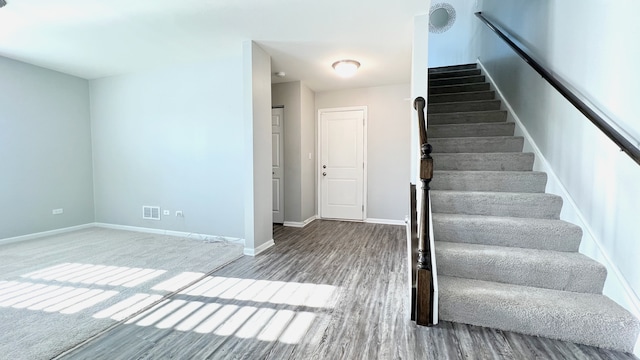 stairs with hardwood / wood-style flooring