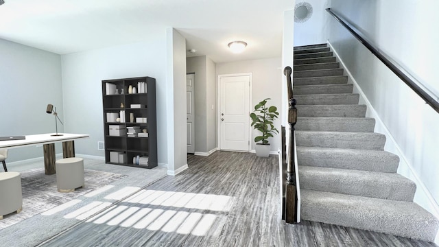 stairway featuring hardwood / wood-style flooring