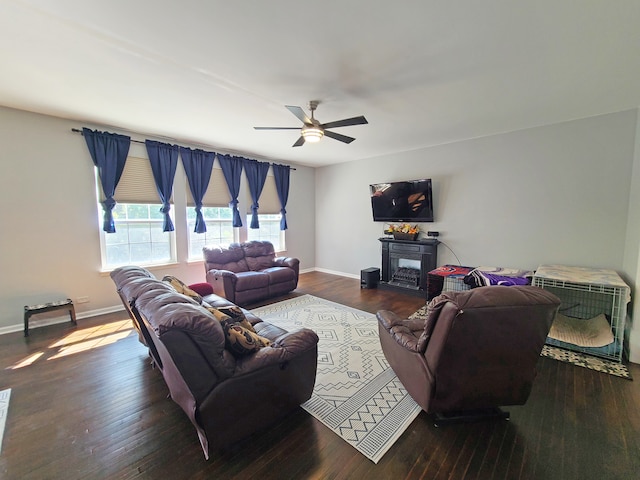 living room with ceiling fan, a fireplace, and hardwood / wood-style flooring