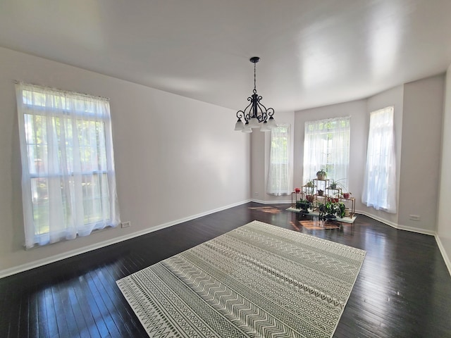 dining space with a chandelier and dark hardwood / wood-style flooring