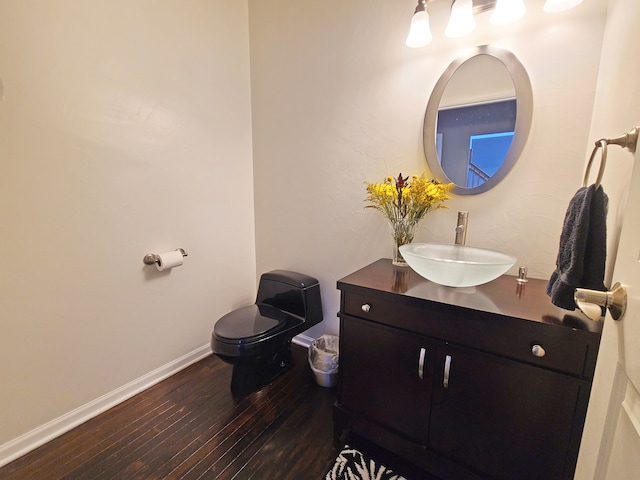 bathroom featuring hardwood / wood-style flooring, vanity, and toilet