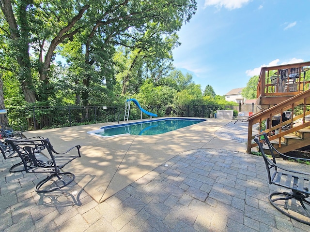 view of pool featuring a patio and a water slide