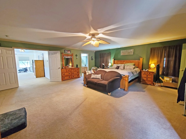 carpeted bedroom with ceiling fan and crown molding