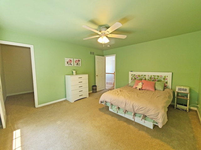 carpeted bedroom featuring heating unit and ceiling fan