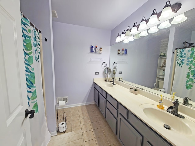 bathroom featuring tile patterned flooring and vanity