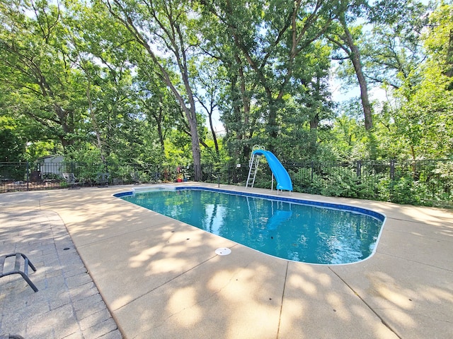 view of swimming pool featuring a patio area and a water slide