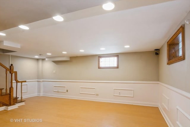 basement with recessed lighting, stairway, baseboards, and light wood-style flooring