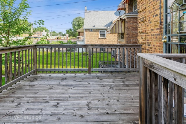 wooden deck with a lawn