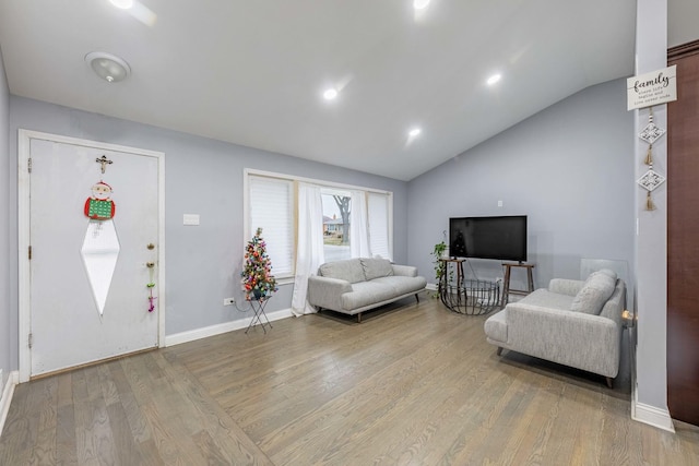 living room with hardwood / wood-style floors and vaulted ceiling