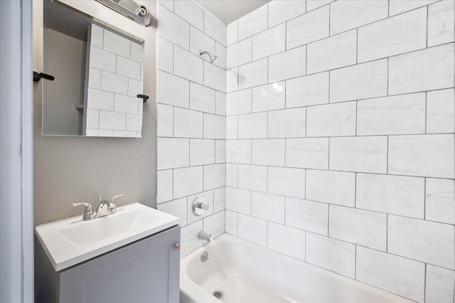 bathroom featuring vanity and tiled shower / bath