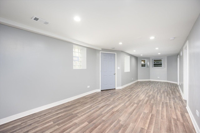 basement with light hardwood / wood-style flooring