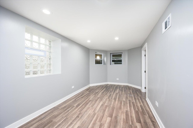 unfurnished room with hardwood / wood-style flooring