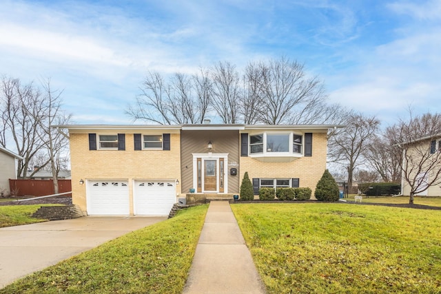 split foyer home with a garage and a front lawn