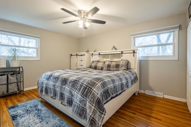 bedroom featuring ceiling fan and dark wood-type flooring