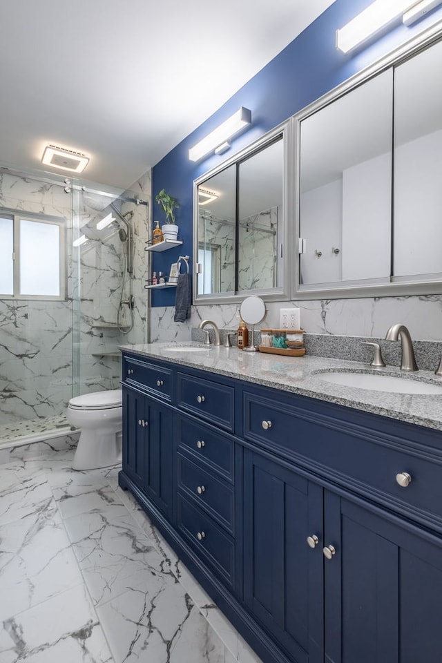 bathroom with vanity, toilet, and a shower with door