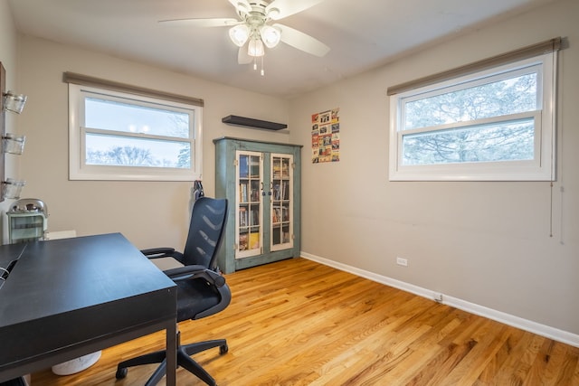 office with ceiling fan and light wood-type flooring