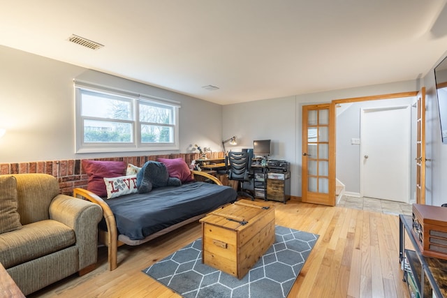 bedroom featuring hardwood / wood-style flooring and french doors