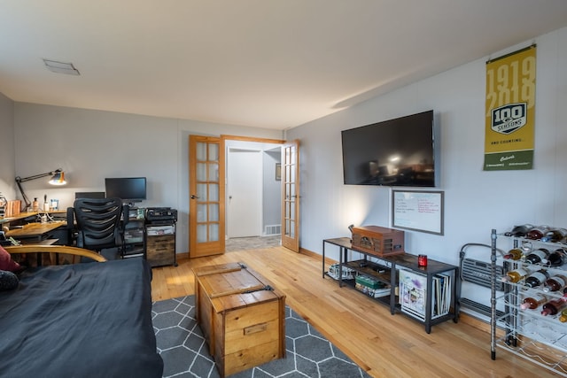 living room featuring hardwood / wood-style flooring and french doors