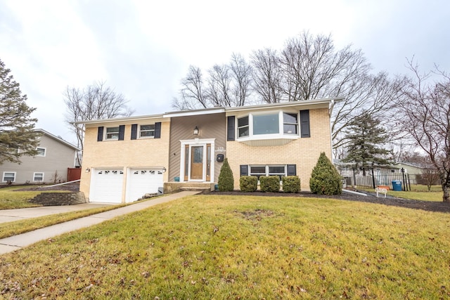 bi-level home with a garage and a front yard