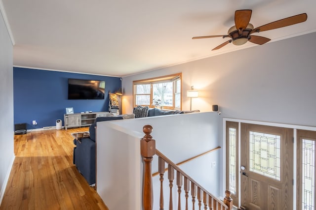 interior space featuring hardwood / wood-style flooring, ceiling fan, and crown molding