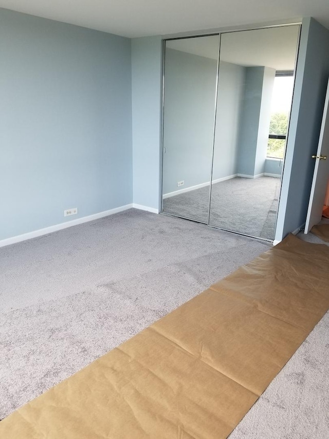 unfurnished bedroom featuring a closet and carpet