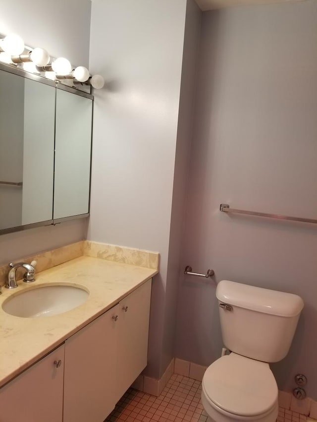 bathroom featuring tile patterned floors, vanity, and toilet