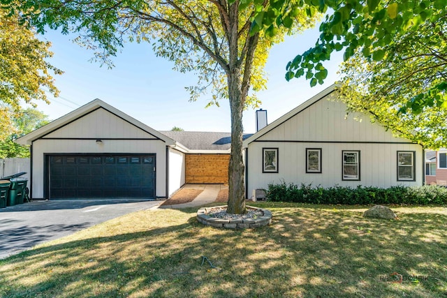 view of front of home with a garage and a front lawn