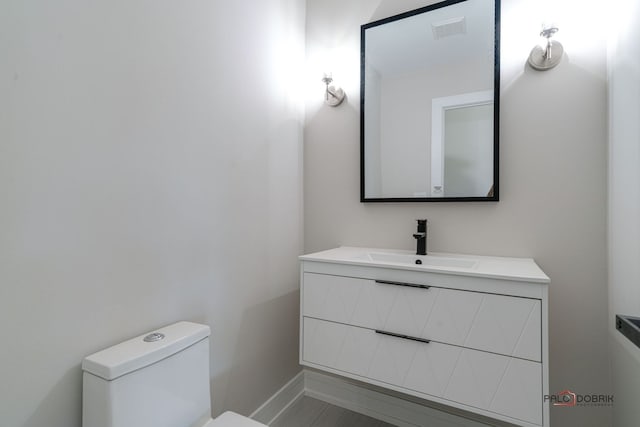 bathroom featuring vanity and toilet