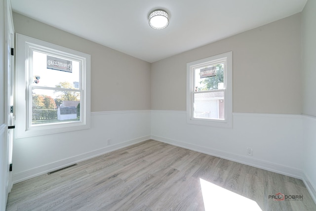 empty room with light hardwood / wood-style floors