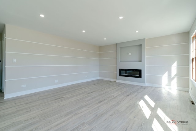 unfurnished living room featuring light hardwood / wood-style floors