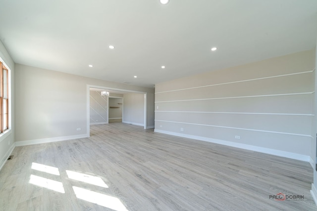 spare room featuring light wood-type flooring and a wealth of natural light