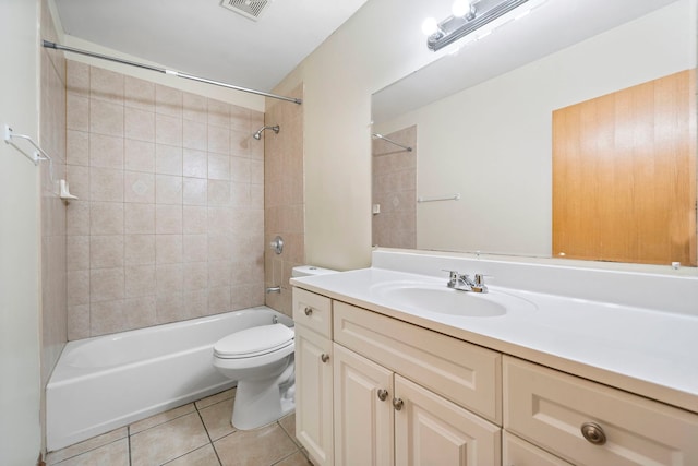 full bathroom featuring tile patterned floors, vanity, toilet, and tiled shower / bath