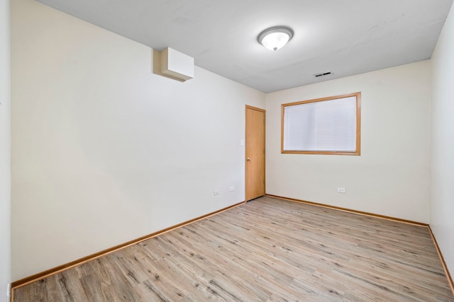 spare room featuring light hardwood / wood-style floors