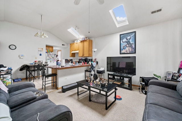 carpeted living room with lofted ceiling with skylight and ceiling fan