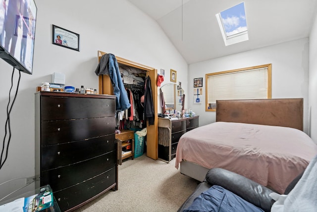 bedroom featuring a closet, vaulted ceiling with skylight, and carpet floors