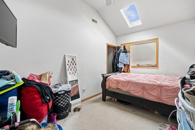 bedroom with vaulted ceiling with skylight and carpet floors