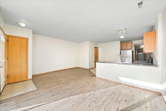 unfurnished living room featuring light wood-type flooring