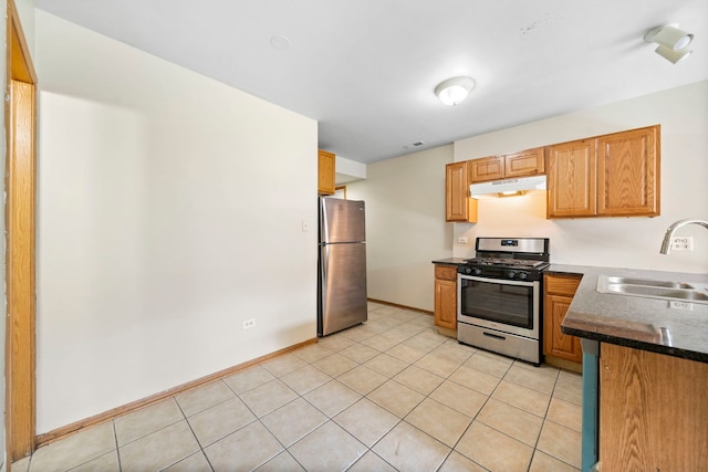 kitchen with sink, light tile patterned floors, and appliances with stainless steel finishes