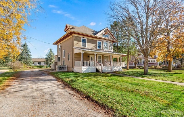 view of front facade with covered porch and a front yard