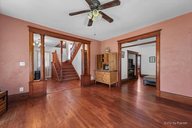 unfurnished living room featuring ceiling fan and dark hardwood / wood-style flooring