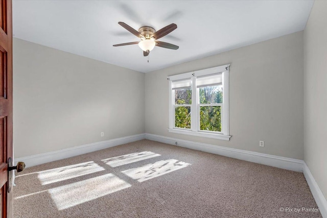 unfurnished room featuring light colored carpet and ceiling fan