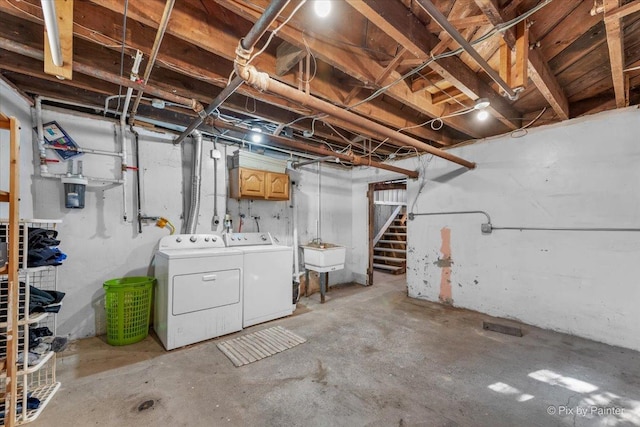 basement with sink and washing machine and clothes dryer