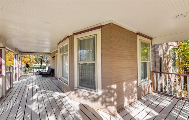 wooden terrace featuring covered porch