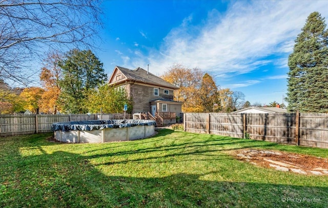 view of yard with a covered pool