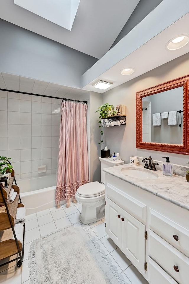 full bathroom featuring vanity, vaulted ceiling, shower / tub combo with curtain, tile patterned flooring, and toilet