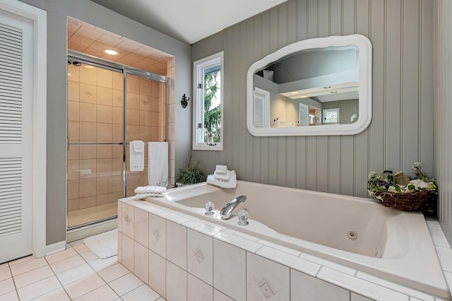 bathroom with separate shower and tub and tile patterned floors