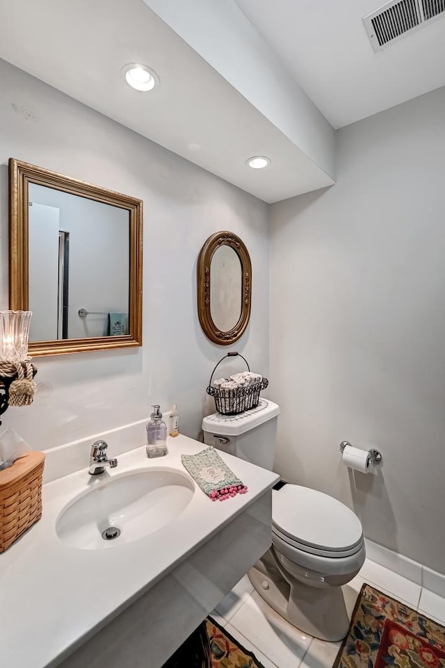 bathroom with toilet, tile patterned floors, and sink